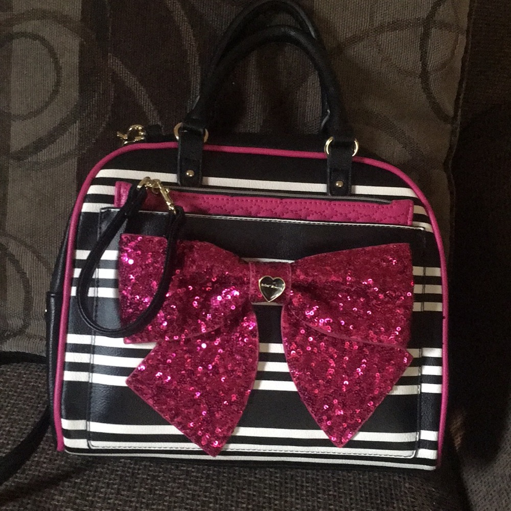 Betsey Johnson handbag with body strap.